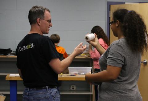 volunteer helping student with science project