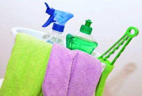 spray bottle with towels and soap in bucket