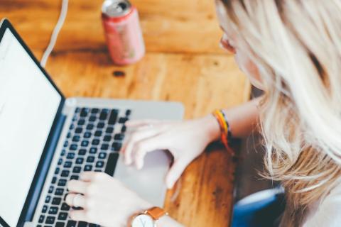 person on a computer looking for online resources 