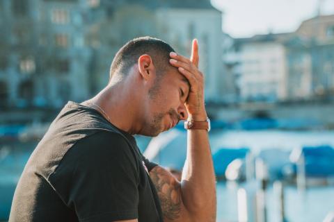Man holding his head in his hands