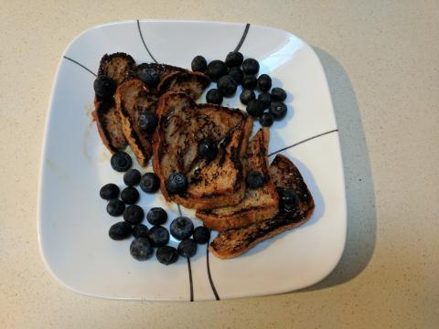 Plate with french toast and fresh blueberries.