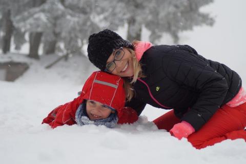 A woman and child in the snow.