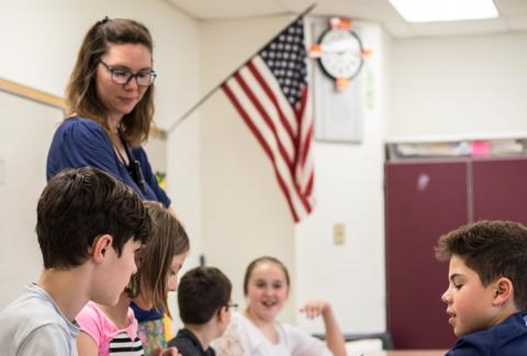 A teacher in a classroom with her students.