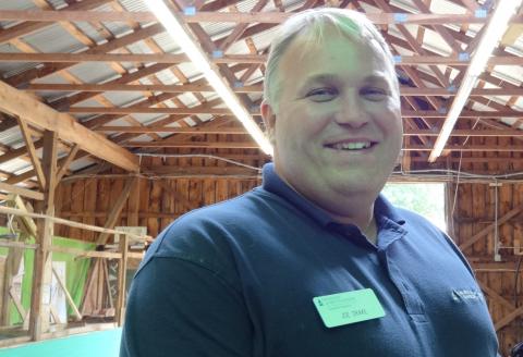 Joe Drake poses in a barn