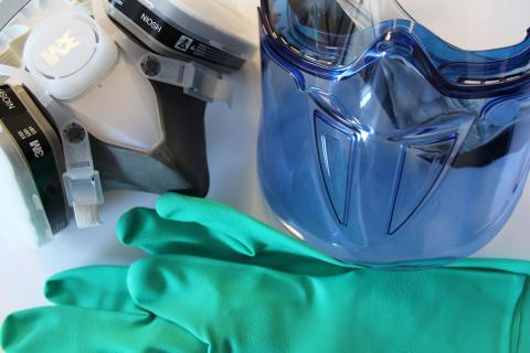 Mask, gloves, and gear associated with pesticide certification in New Hampshire.