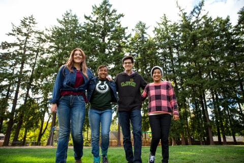 four teens standing shoulder to shoulder