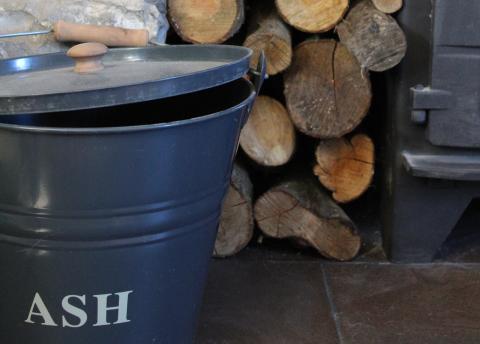 ash bucket next to wood stove