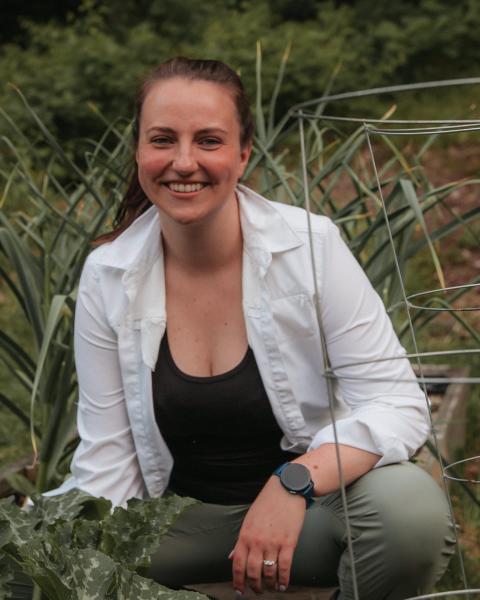 Liza DeGenring kneeling in garden