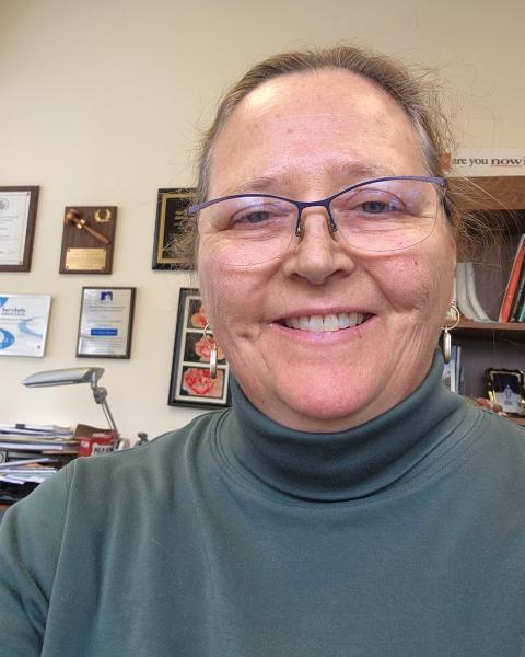 headshot of woman in turtleneck sweater
