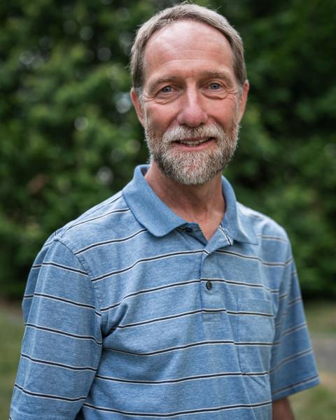 Man in striped blue polo shirt