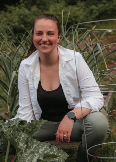 Liza DeGenring kneeling in garden