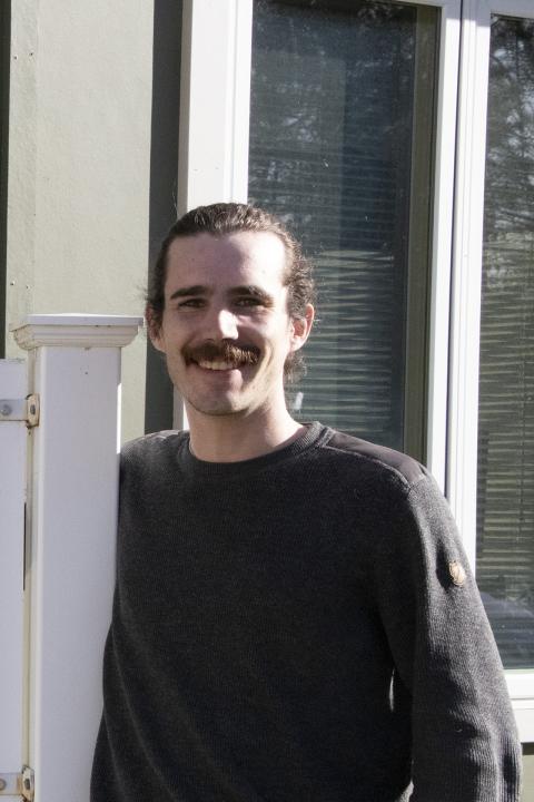 Will Hastings standing next to Coos County Extension sign