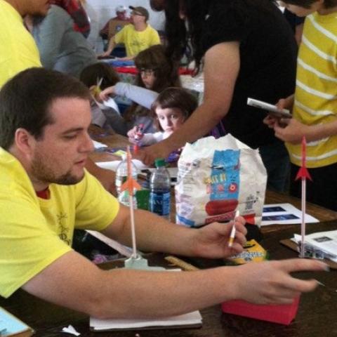 man working with a toy rocket