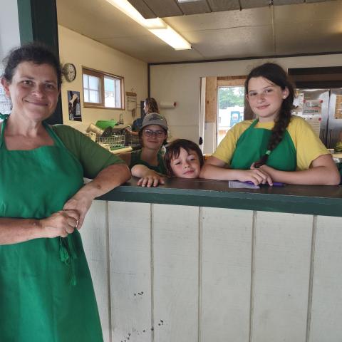 Leader and Members working 4-H Food Booth