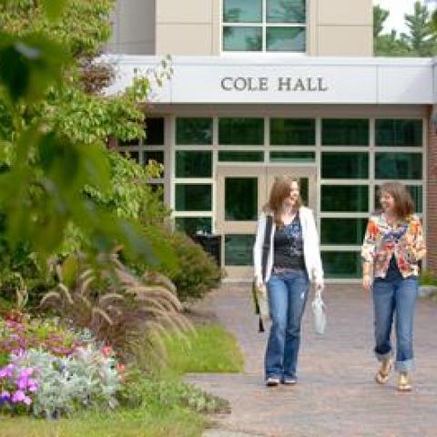 Two people walking away from a building
