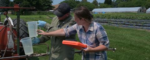 Farmers checking calibration of a sprayer