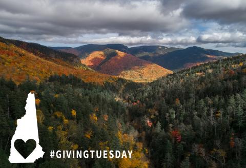 fall mountains and hills with colorful leaves, State with cutout heart and text giving tuesday